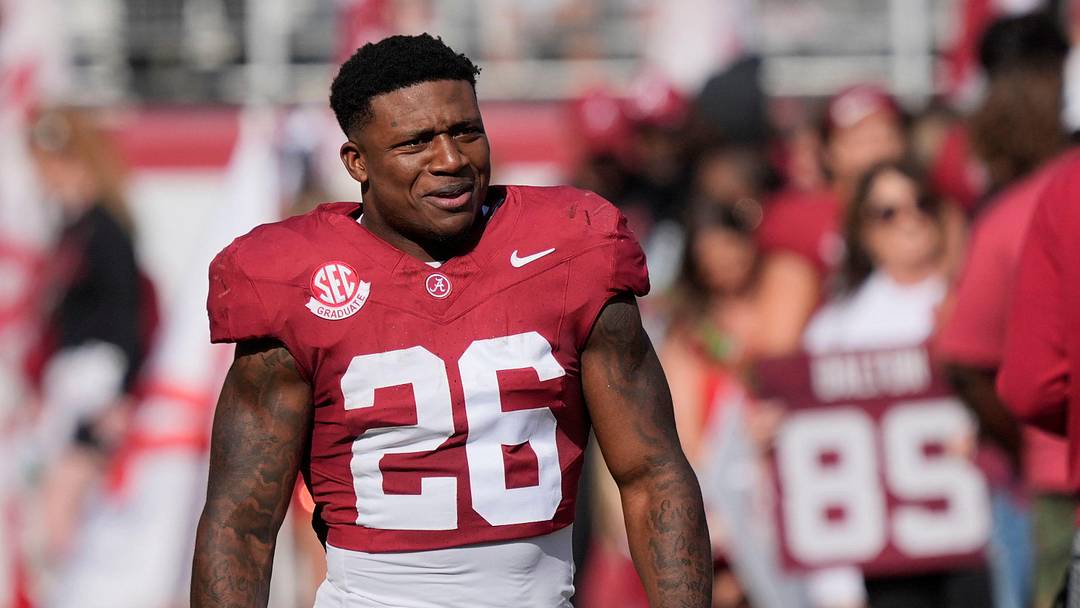 Nov 22, 2025; Tuscaloosa, Alabama, USA; Alabama running back Jam Miller (26) walks to his family with a rose in hand on Senior Day at Saban Field at Bryant-Denny Stadium.