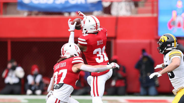 Nov 24, 2023; Lincoln, Nebraska, USA; Nebraska Cornhuskers defensive back Tommi Hill intercepts a pass intended for Iowa Hawkeyes wide receiver Nico Ragaini at Memorial Stadium.