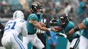 Dec 7, 2025; Jacksonville, Florida, USA; Jacksonville Jaguars running back Travis Etienne Jr. (1) takers the hand off from quarterback Trevor Lawrence (16) against the Indianapolis Colts during the first half at EverBank Stadium. Mandatory Credit: Matt Pendleton-Imagn Images