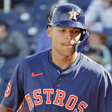 Feb 22, 2025; West Palm Beach, Florida, USA; Houston Astros infielder Cam Smith (left) is congratulated by teammate Tommy Sacco Jr. (87) after scoring a run in the ninth inning against the Washington Nationals at CACTI Park of the Palm Beaches.