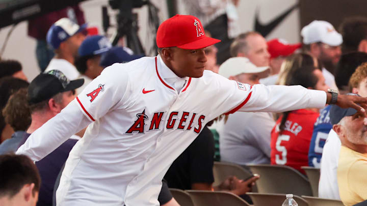 Jul 14, 2024; Ft. Worth, TX, USA;  Christian Moore celebrates with fans after being selected by the Los Angeles Angels as the eight player taken during the first round of the MLB Draft at Cowtown Coliseum. 