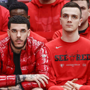 Apr 22, 2022; Chicago, Illinois, USA; Chicago Bulls guard Lonzo Ball (center) looks on from the bench during the second half of Game 3 of the first round for the 2022 NBA playoffs against the Milwaukee Bucks at United Center. 
