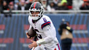 New York Giants quarterback Jaxson Dart (6) rushes the ball against the Chicago Bears during the second half at Soldier Field. 