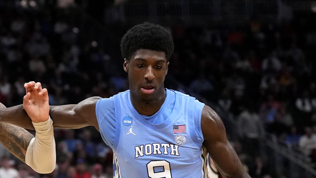 Mar 21, 2025; Milwaukee, WI, USA; North Carolina Tar Heels wing Drake Powell (9) drives against Mississippi Rebels guard Dre Davis (14) during the second half of a first round NCAA men’s tournament game at Fiserv Forum. Mandatory Credit: Jeff Hanisch-Imagn Images