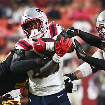 Aug 25, 2024; Landover, Maryland, USA; New England Patriots running back Terrell Jennings (29)  runs through the line during the second  half against the Washington Commanders at Commanders Field. Mandatory Credit: Tommy Gilligan-Imagn Images