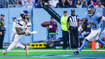 Seattle Seahawks wide receiver Jaxon Smith-Njigba (11) catches a touchdown pass around Tennessee Titans cornerback Samuel Womack III (35) during the third quarter at Nissan Stadium in Nashville, Tenn., Sunday, Nov. 23, 2025.