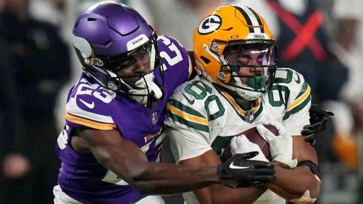 Green Bay Packers wide receiver Bo Melton (80) catches a 37-yard before being tackled by Minnesota Vikings cornerback Andrew Booth Jr. (23) during the fourth quarter of their game Sunday, December 31, 2023 at U.S. Bank Stadium in Minneapolis, Minnesota. The Green Bay Packers beat the Minnesota Vikings 33-10.