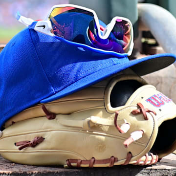 Feb 27, 2024; Mesa, Arizona, USA;  General view of a Chicago Cubs glove, hat and glasses in the first inning against the Cincinnati Reds during a spring training game at Sloan Park.