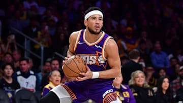 Phoenix Suns guard Devin Booker (1) controls the ball against the against the Los Angeles Lakers during the first half at Crypto.com Arena. Mandatory Credit: Gary A. Vasquez-Imagn Images