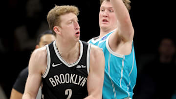 Dec 1, 2025; Brooklyn, New York, USA; Brooklyn Nets forward Danny Wolf (2) looks to pass the ball against Charlotte Hornets guard Kon Knueppel (7) during the first quarter at Barclays Center. Mandatory Credit: Brad Penner-Imagn Images