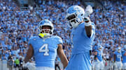 Sep 13, 2025; Chapel Hill, North Carolina, USA; North Carolina Tar Heels wide receiver Jordan Shipp (1) celebrates with wide receiver Alex Taylor (0) and running back Caleb Hood (4) after making a touchdown catch in the third quarter at Kenan Stadium. Mandatory Credit: Bob Donnan-Imagn Images