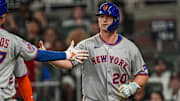 Aug 23, 2025; Cumberland, Georgia, USA; New York Mets first baseman Pete Alonso (20) reacts with third baseman Mark Vientos (27) after hitting a two run home run against the Atlanta Braves during the seventh inning at Truist Park. Mandatory Credit: Dale Zanine-Imagn Images