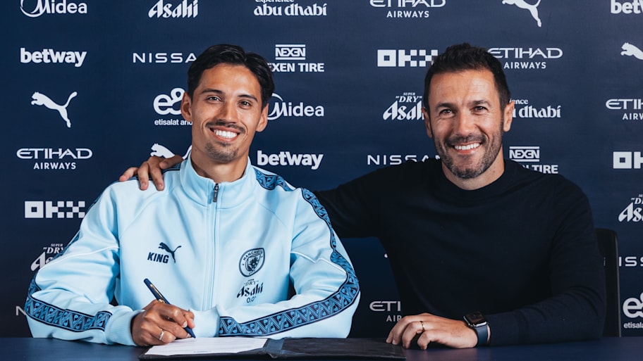 Tijjani Reijnders posing alongside Manchester City sporting director.