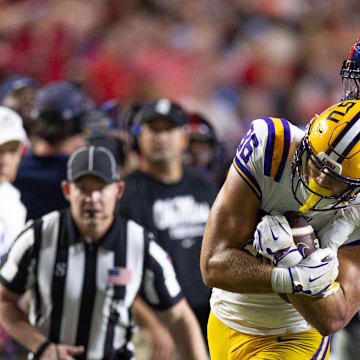 Mississippi cornerback Trey Amos tackles LSU tight end Mason Taylor.