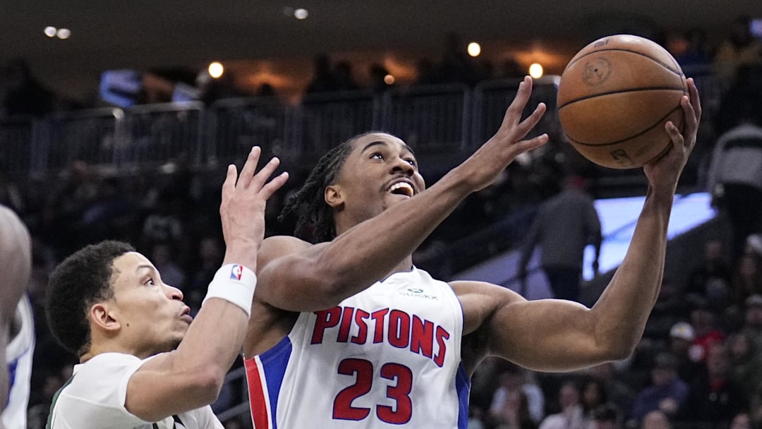 Nov 22, 2025; Milwaukee, Wisconsin, USA; Detroit Pistons guard Jaden Ivey (23) puts up a shot against Milwaukee Bucks guard Ryan Rollins (13) in the second half at Fiserv Forum. Mandatory Credit: Michael McLoone-Imagn Images
