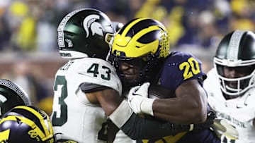 Oct 26, 2024; Ann Arbor, Michigan, USA;  Michigan Wolverines running back Kalel Mullings (20) itb Michigan State Spartans defensive back Malik Spencer (43) in the first half at Michigan Stadium.