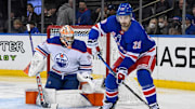 Dec 22, 2023; New York, New York, USA;  New York Rangers left wing Chris Kreider (20) plays the puck in front of Edmonton Oilers goaltender Stuart Skinner (74) during the second period at Madison Square Garden. Mandatory Credit: Dennis Schneidler-Imagn Images