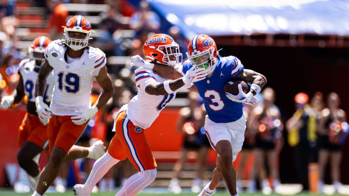 Florida Gators wide receiver Eugene Wilson III (3) stiff arms Florida Gators defensive back Sharif Denson (0) during the first half at the Orange and Blue spring football game at Steve Spurrier Field at Ben Hill Griffin Stadium in Gainesville, FL on Saturday, April 13, 2024. [Matt Pendleton/Gainesville Sun]