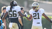Jul 28, 2025; Metairie, LA, USA;  New Orleans Saints linebacker Demario Davis (56) and safety Justin Reid (21) shake hands during training camp at Ochsner Sports Performance Center. Mandatory Credit: Stephen Lew-Imagn Images