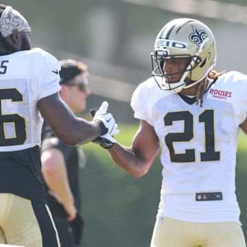 Jul 28, 2025; Metairie, LA, USA;  New Orleans Saints linebacker Demario Davis (56) and safety Justin Reid (21) shake hands during training camp at Ochsner Sports Performance Center. Mandatory Credit: Stephen Lew-Imagn Images