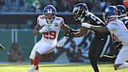 Jan 5, 2025; Philadelphia, Pennsylvania, USA;  New York Giants running back Tyrone Tracy Jr. (29) runs past Philadelphia Eagles linebacker Jeremiah Trotter Jr. (54) during the second quarter at Lincoln Financial Field.  