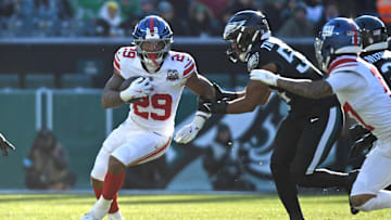 Jan 5, 2025; Philadelphia, Pennsylvania, USA;  New York Giants running back Tyrone Tracy Jr. (29) runs past Philadelphia Eagles linebacker Jeremiah Trotter Jr. (54) during the second quarter at Lincoln Financial Field.  
