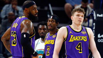  Los Angeles Lakers forward LeBron James (23) and guard Dalton Knecht (4) react during the second quarter against the Memphis Grizzlies at FedExForum.