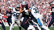 Sep 28, 2025; Foxborough, Massachusetts, USA; New England Patriots tight end Hunter Henry (85) runs against Carolina Panthers linebacker Trevin Wallace (32) during the first half at Gillette Stadium. 