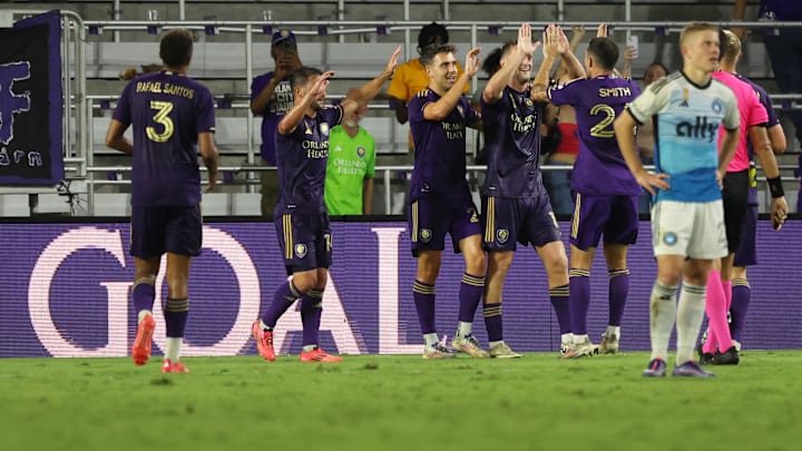 Sep 18, 2024; Orlando, Florida, USA; Orlando City forward Duncan McGuire (13) is congratulated by teammates after he scored a goal against Charlotte FC during the second half at Inter&Co Stadium. Mandatory Credit: Kim Klement Neitzel-Imagn Images