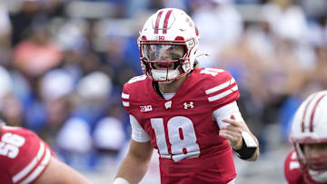 Sep 6, 2025; Madison, Wisconsin, USA; Wisconsin Badgers quarterback Danny O'Neil (18) yells to the offense during the first quarter against the Middle Tennessee Blue Raiders at Camp Randall Stadium. Mandatory Credit: Kayla Wolf-Imagn Images