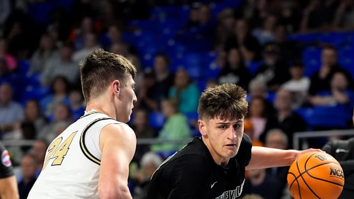 Greeneville's Trey Thompson (21) bolts past Upperman's Colton Johnson (24) during the first quarter of a TSSAA Class 3A basketball state semifinal game at the Murphy Center in Murfreesboro, Tenn., Friday, March 21, 2025.