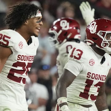 Michael Boganowski (25) and defensive back Reggie Powers III 