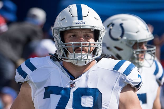 Indianapolis Colts center Ryan Kelly (78) enters the field in a white jersey.