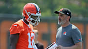 Cleveland Browns quarterback Shedeur Sanders speaks with coach Kevin Stefanski during practice at minicamp June 11, 2025, in Berea, Ohio.