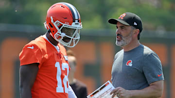 Cleveland Browns quarterback Shedeur Sanders speaks with head coach Kevin Stefanski during practice at NFL minicamp