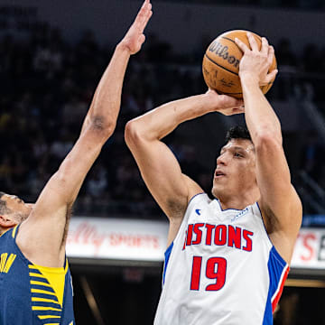 Feb 22, 2024; Indianapolis, Indiana, USA; Detroit Pistons forward Simone Fontecchio (19) shoots the ball while Indiana Pacers guard Tyrese Haliburton (0) defends in the first half at Gainbridge Fieldhouse. Mandatory Credit: Trevor Ruszkowski-Imagn Images