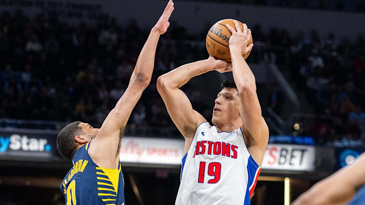 Feb 22, 2024; Indianapolis, Indiana, USA; Detroit Pistons forward Simone Fontecchio (19) shoots the ball while Indiana Pacers guard Tyrese Haliburton (0) defends in the first half at Gainbridge Fieldhouse. Mandatory Credit: Trevor Ruszkowski-Imagn Images