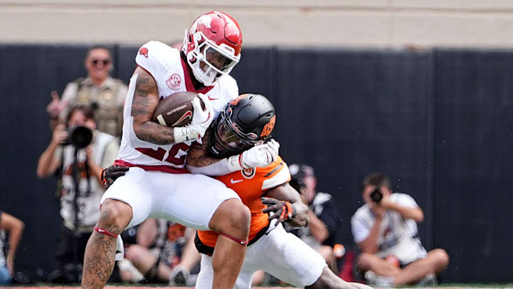 Oklahoma State's Nick Martin (4) tackles Arkansas' Ja'Quinden Jackson (22) first half of the college football game between the Oklahoma State Cowboys and the Arkansas Razorbacks at Boone Pickens Stadium in Stillwater, Okla.,, Saturday, Sept., 7, 2024.