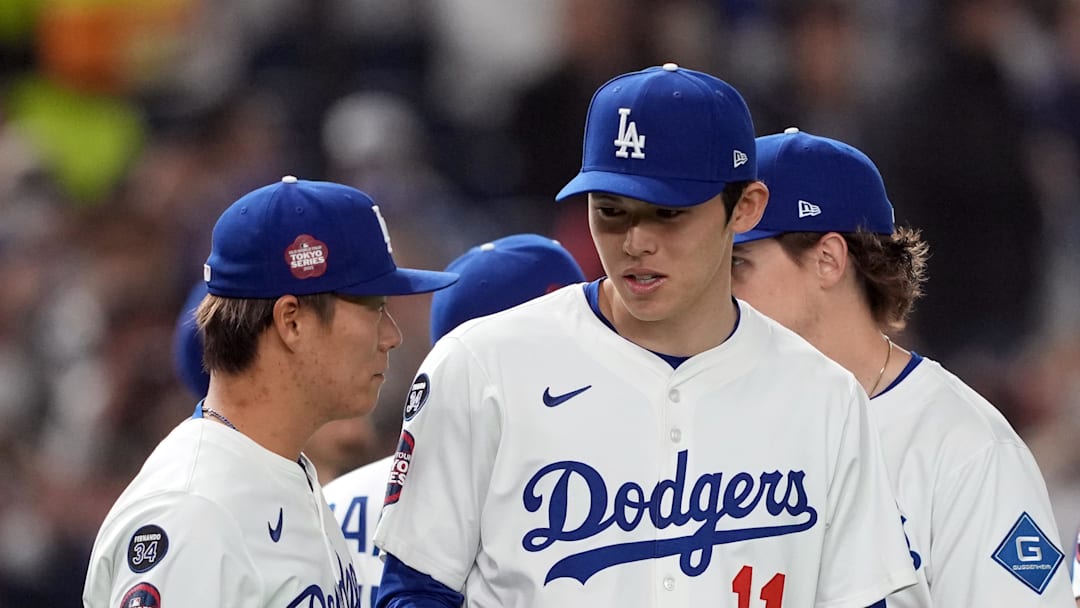 Los Angeles Dodgers pitcher Roki Sasaki (11) talks with pitcher Yoshinobu Yamamoto (left) before the game against the Hanshin Tigers at Tokyo Dome on March 16. Los Angeles Dodgers pitcher Roki Sasaki (11) talks with pitcher Yoshinobu Yamamoto (left) before the game against the Hanshin Tigers at Tokyo Dome on March 16.