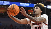 Jan 1, 2025; Louisville, Kentucky, USA;  Louisville Cardinals guard Chucky Hepburn (24) shoots against North Carolina Tar Heels guard Ian Jackson (11) during the second half at KFC Yum! Center.
