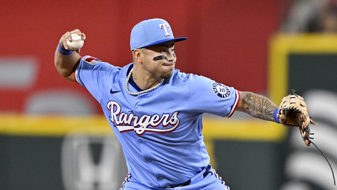 Sep 21, 2025; Arlington, Texas, USA; Texas Rangers second baseman Cody Freeman (39) throws to first base as he turns a double play against the Miami Marlins during the sixth inning at Globe Life Field. Mandatory Credit: Jerome Miron-Imagn Images