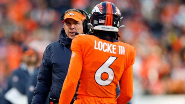 Nov 26, 2023; Denver, Colorado, USA; Denver Broncos head coach Sean Payton talks with safety P.J. Locke (6) in the third quarter against the Cleveland Browns at Empower Field at Mile High. 