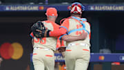 Jul 16, 2024; Arlington, Texas, USA; American League pitcher Kirby Yates of the Texas Rangers (39) and catcher Salvador Perez of the Kansas City Royals (13) react in the eighth inning during the 2024 MLB All-Star game at Globe Life Field.