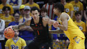 Feb 15, 2025; Pittsburgh, Pennsylvania, USA; Miami (Fl) Hurricanes center Lynn Kidd (1) handles the ball against Pittsburgh Panthers forward Cameron Corhen (2) during the second half at the Petersen Events Center. Mandatory Credit: Charles LeClaire-Imagn Images