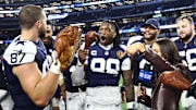 Dallas Cowboys players celebrate with a turkey after beating the Kansas City Chiefs on Thanksgiving at AT&T Stadium.