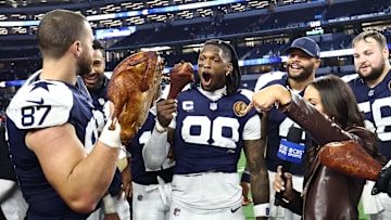 Dallas Cowboys players celebrate with a turkey after beating the Kansas City Chiefs on Thanksgiving at AT&T Stadium.