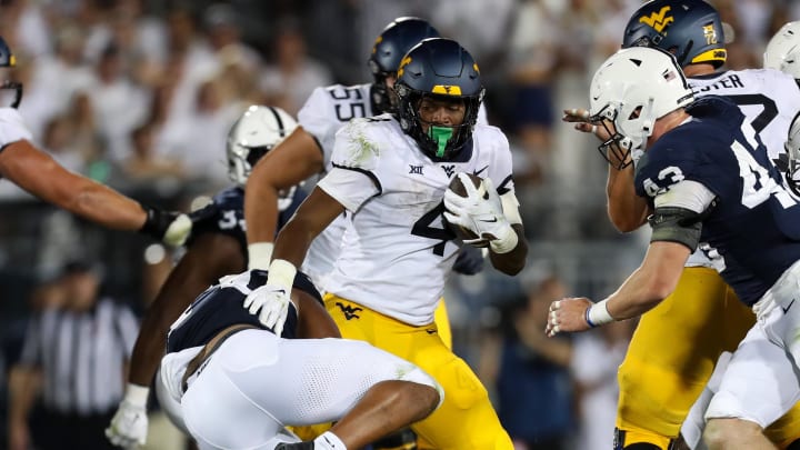 Sep 2, 2023; University Park, Pennsylvania, USA; West Virginia Mountaineers running back CJ Donaldson Jr. (4) runs the ball against the Penn State Nittany Lions during the fourth quarter at Beaver Stadium. Penn State won 38-15. 