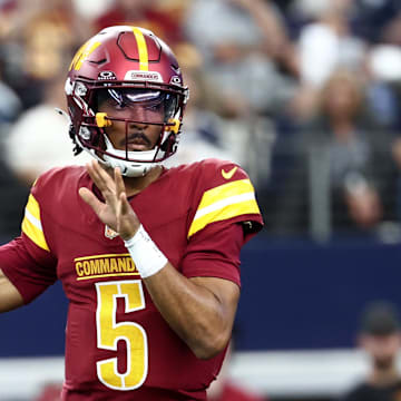 Oct 19, 2025; Arlington, Texas, USA; Washington Commanders quarterback Jayden Daniels (5) passes the ball against the Dallas Cowboys during the first quarter of the game at AT&T Stadium. Mandatory Credit: Kevin Jairaj-Imagn Images