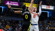 Dec 30, 2023; Indianapolis, Indiana, USA; New York Knicks guard Donte DiVincenzo (0) shoots the ball over Indiana Pacers guard Tyrese Haliburton (0).