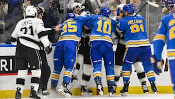 Mar 1, 2025; St. Louis, Missouri, USA;  St. Louis Blues center Jordan Kyrou (25) and Los Angeles Kings defenseman Jacob Moverare (43) fight during the third period at Enterprise Center. Mandatory Credit: Jeff Curry-Imagn Images